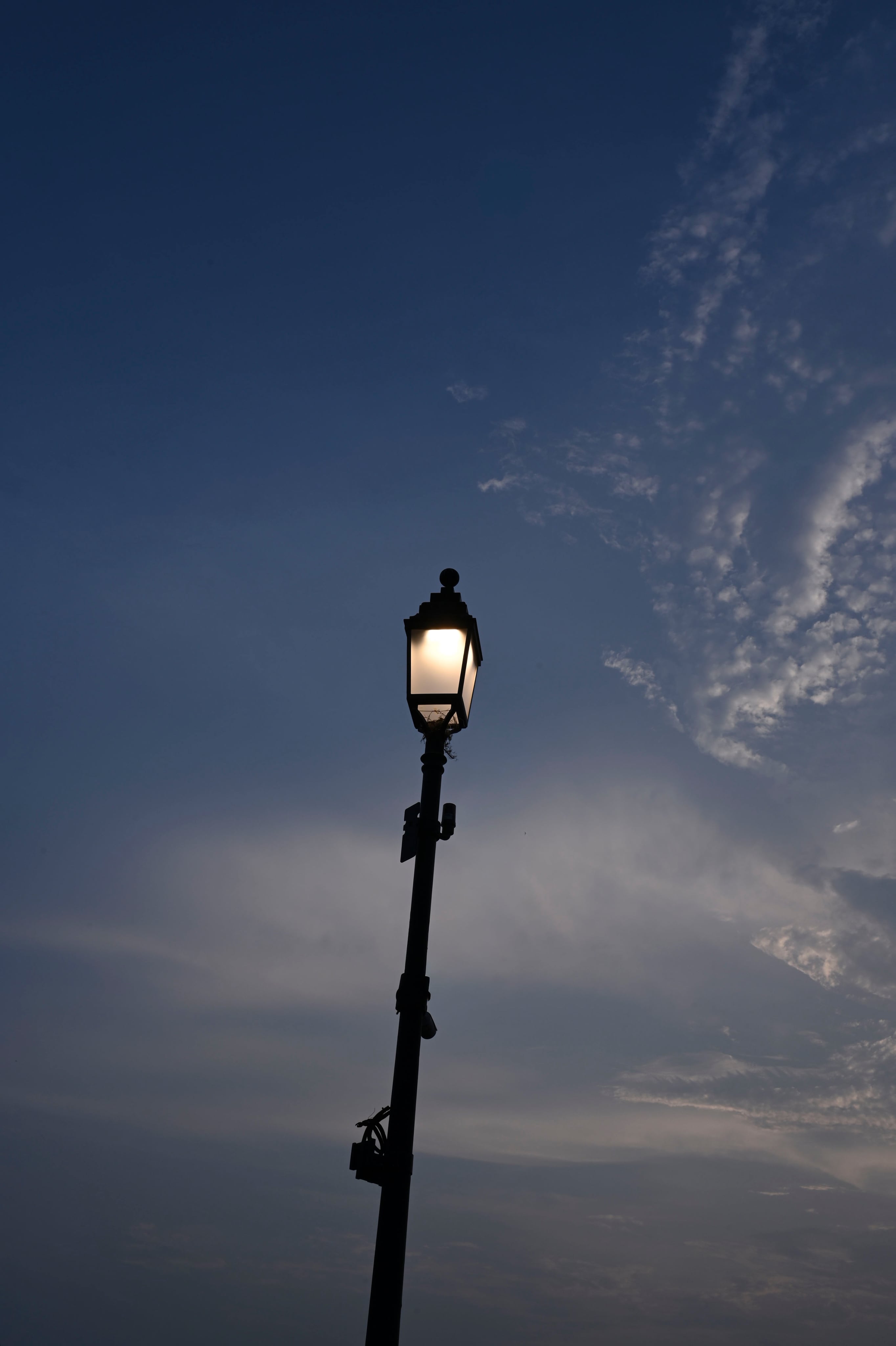 A photographer framing a moment on a camera at sunset